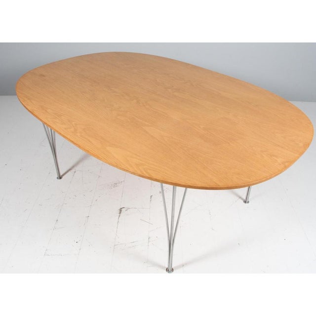 Piet Hein & Bruno Mathsson dining table with originale top of oak. Chrome legs. Made by Fritz Hansen. This piece is...