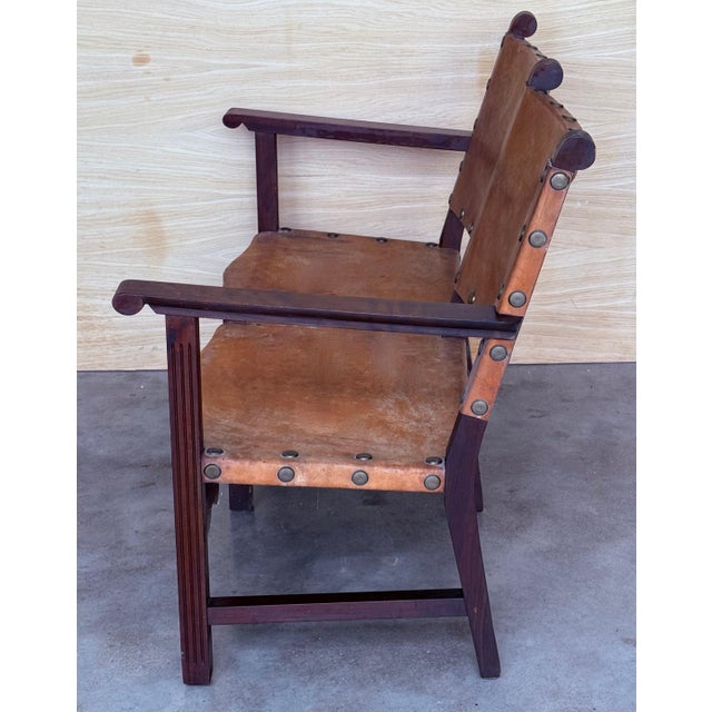 Doble Armchair or Sofa with arms and high back of the type known as “frailero”, which has leather with studs on the seat...