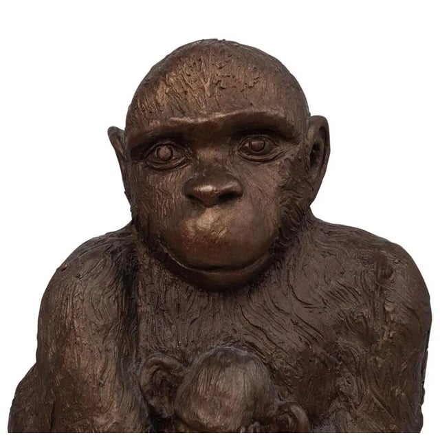 Vintage composite seated monkey figurine. Features a mother and child depiction and finished with a black round marble...