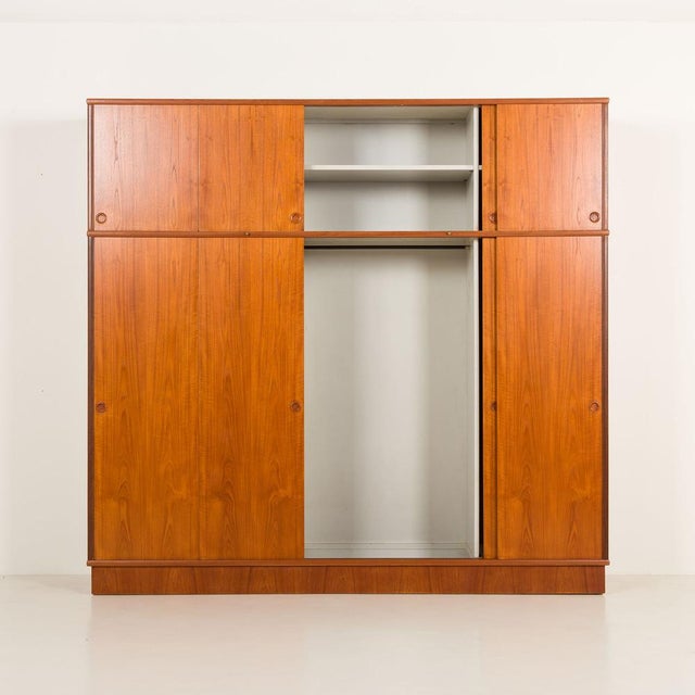 This very rare danish mid-century extra-large teak wardrobe was designed by melvin mikkelsen and made by melvin mikkelsen...