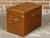 An English Turn of the Century leather trunk from circa 1900 with brass accents, lateral handles and monogram. This...