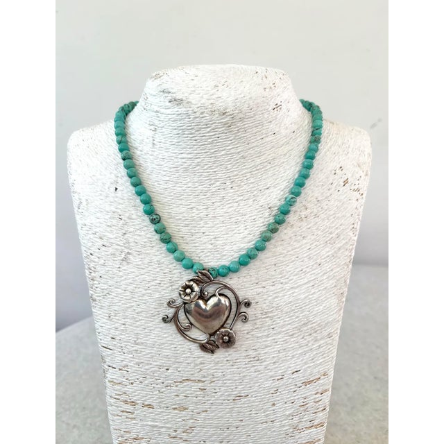 Lovely turquoise beaded necklace with vintage sterling silver pendant. Adjustable.