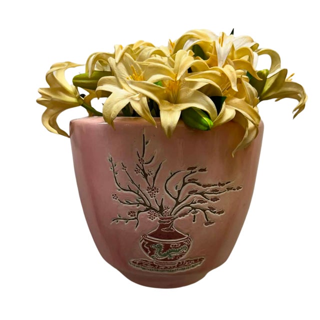 A charming vintage ceramic wall planter finished in a soft blush pink glaze and decorated with an elegant Oriental-...