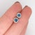 Make a statement with these icy blue Blue Diamond stud earrings, set in solid 14K White Gold. Each earring centers a hand-...