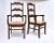 A pair of scalloped, high ladder-back chairs with contoured armrests, carved apron detailing, H stretchers & classic hand...