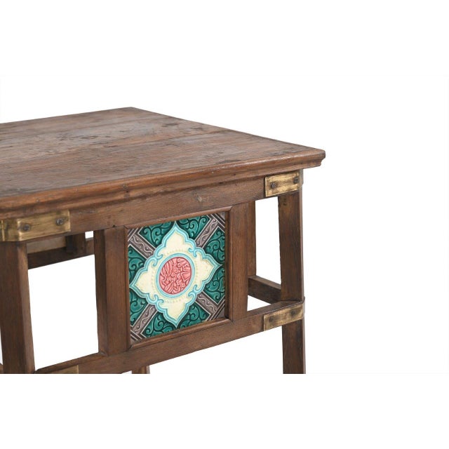 This Vintage Indian Teakwood and Tile Side Table is constructed from solid teakwood, featuring brass corner details and...