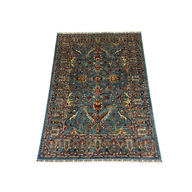 This hand-knotted Sultani Chobi rug is made from naturally dyed wool. Its deep blue field features scrolling vines and...