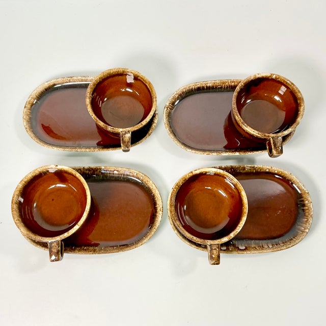From Hull Pottery, this is a set of Lava Drip Brown Glazed Ironstone Pottery. The set is 8 pieces of 4 Soup Mugs and 4...