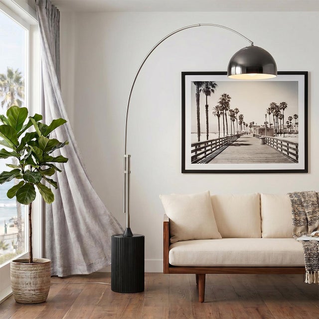 The Tambo Arc Lamp is a striking Mid-Century Modern lighting piece designed by Peter Morelli in 1984. This arc lamp...