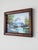 A framed Mid Century oil painting depicting a mountain-capped waterfall and lush nature scene, unsigned. Dimensions:...