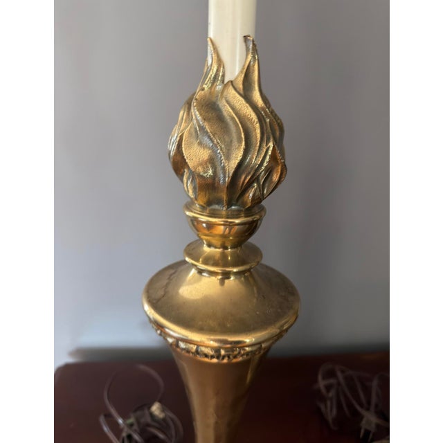 Stunning olympic torch lamps in brass. Rounded base with delicate napoleonic loop and arrow detail tapers up to a...