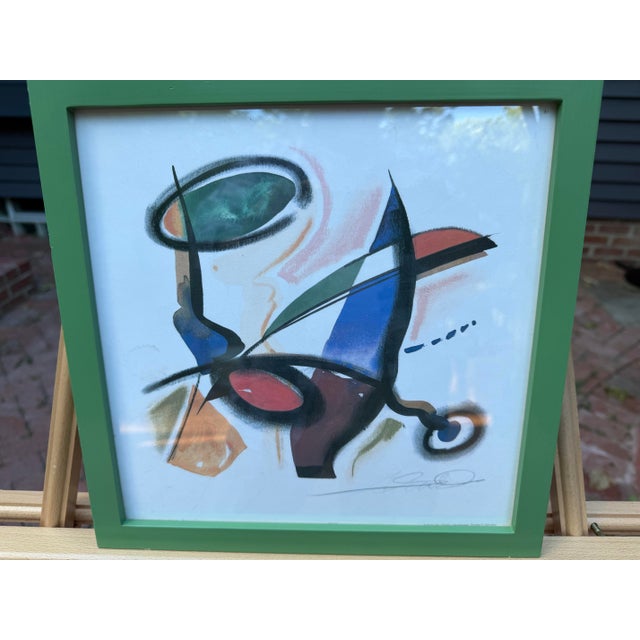 Each of Gockel’s signed abstract print features bold geometric shapes in blue, red, and black. Each print is also framed...