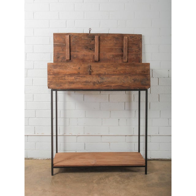 This distinctive Indian wooden storage box is mounted on a custom iron stand, blending traditional craftsmanship with a...