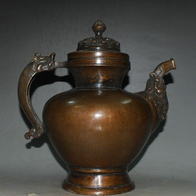 This impressive vessel is masterfully crafted from heavy solid copper with a rich, warm brown patina. It beautifully...
