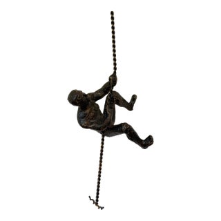 Vintage Modernist Cast Metal Hanging Sculpture of a Man Climbing For Sale