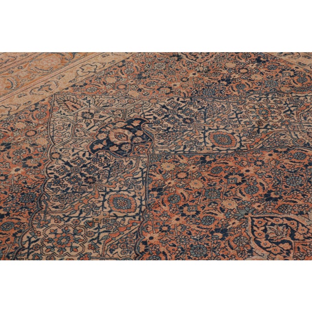 Hand-knotted in wool and originating from late-19th-century Persia, this 8x12 antique Persian rug of Tabriz provenance is...