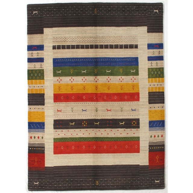 Vintage Hand-knotted Gabbeh rug featuring a vibrant composition of horizontal bands framed within a contrasting border....