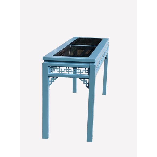 Coastal blue painted vintage console table. Glass top with lovely fretwork apron and chinese Chippendale carved wood...