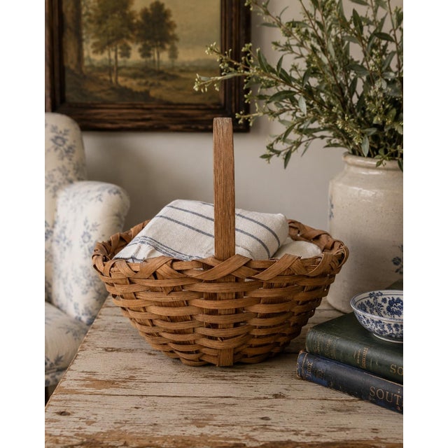 A beautifully woven early 20th century American splint oak basket with warm honeyed tones and a tightly constructed...