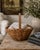 A beautifully woven early 20th century American splint oak basket with warm honeyed tones and a tightly constructed...