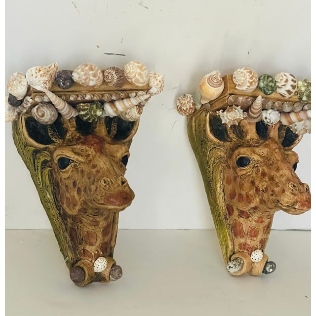 Gorgeous pair of vintage giraffe head wall brackets encrusted with sea shells.