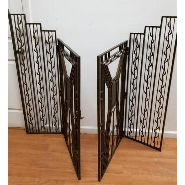 Exceptional Pair of Art Deco Wrought Iron Double Hinged Gates. with Bronze or Gilt Accents. The strong Art Deco geometric...
