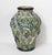 A wonderfully textured vintage pottery vase with raised grape clusters, curling vines, and a trellis motif, finished in...