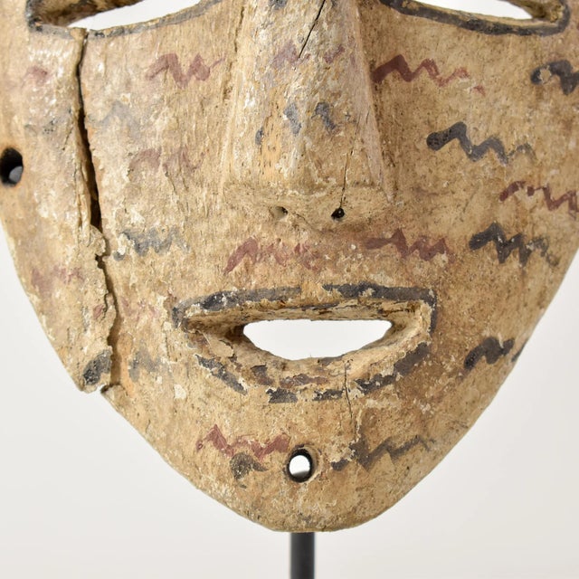 This authentic African mask from the LegaÂ people showcases intricate wood carvings and unique pigmentation. Comes with a...