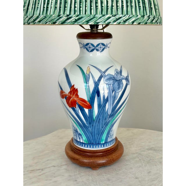 Vibrant 1970s Japanese table lamp on walnut base with a pleated green lampshade. Features a blue, green, and orange...