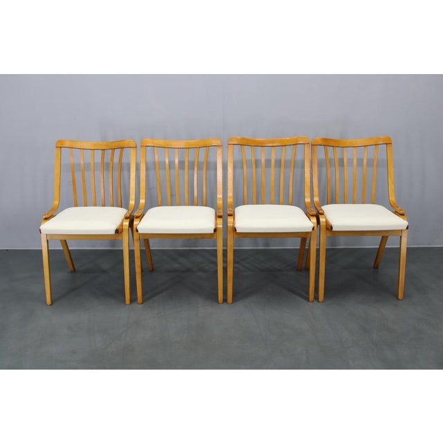 This refined set of four mid-century dining chairs was produced by Jitona in Czechoslovakia during the 1960s. Constructed...