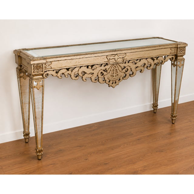 An impressive ornate mirrored console table, attributed to Lam Lee, featuring an elaborate decorative design with strong...