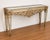 An impressive ornate mirrored console table, attributed to Lam Lee, featuring an elaborate decorative design with strong...