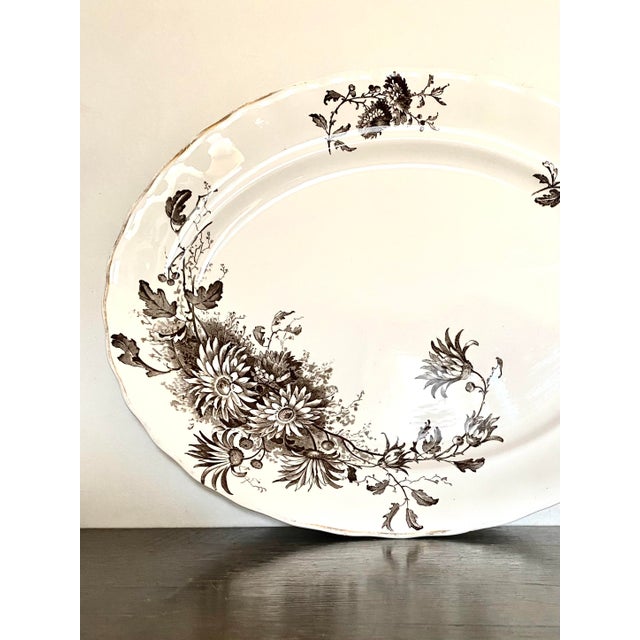 Antique brown transferware on ivory background platter made by the prominent manufacturer, Keeling & Co Ltd which operated...
