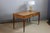 A Directoire-style marquetry desk resting on four tapered legs ending in bronze sabots. It features two drawers in the...