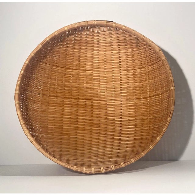 Hand made wicker basket finished with a bamboo frame. Hang as wall art, fill with rolled up hand/ kitchen towels, use as a...