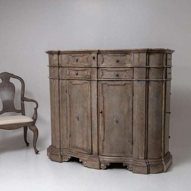 Impressive buffet with four doors and eight drawers, featuring a richly contoured front and a profiled base with volute-...