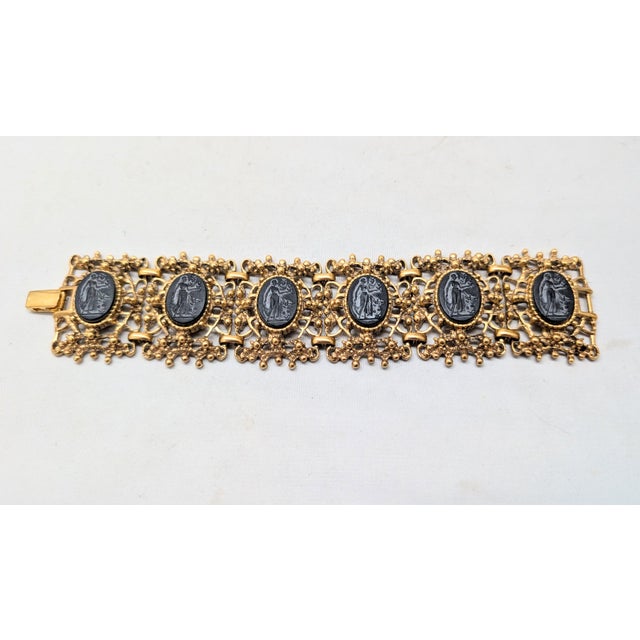 1994 goldtone bumpy texture with oval faux-onyx intaglio of a woman wearing a toga with flying birds link bracelet with...