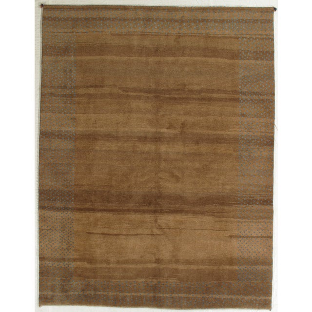 Vintage hand-knotted Persian Gabbeh rug featuring a warm, minimalist field framed by a softly defined border with...