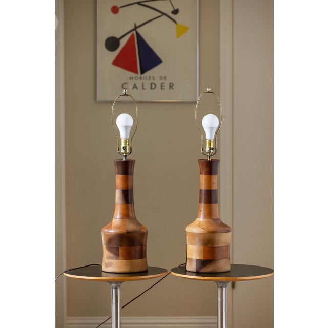 Vintage pair of hand-turned table lamps crafted in a segmented hardwood construction, likely from the 1970s American...