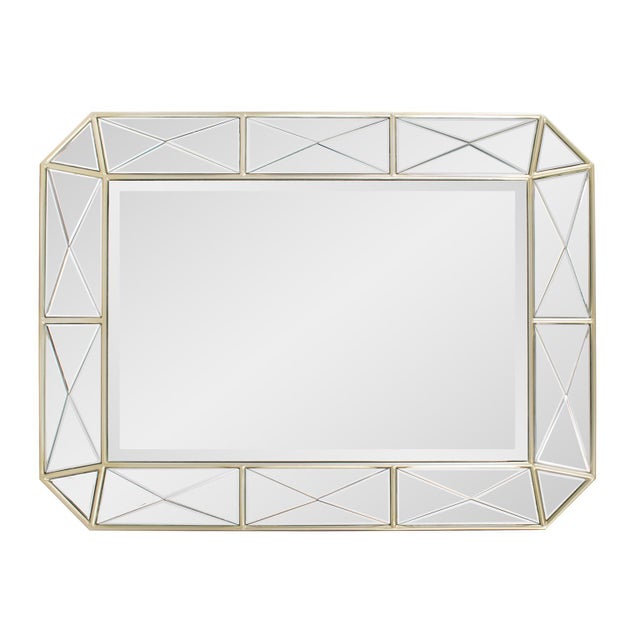 The Diamond Mirror features an exquisite geometric frame with intersecting lines and beveled glass panels, creating a...