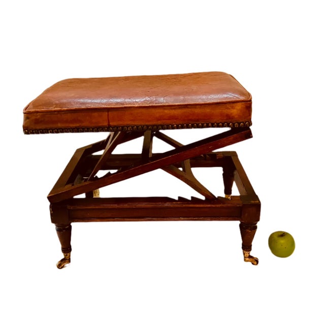 1880's mahogany and leather metamorphic foot stool with nailhead trim and casters. 10.75" H (when lowered) , 21"H (at...