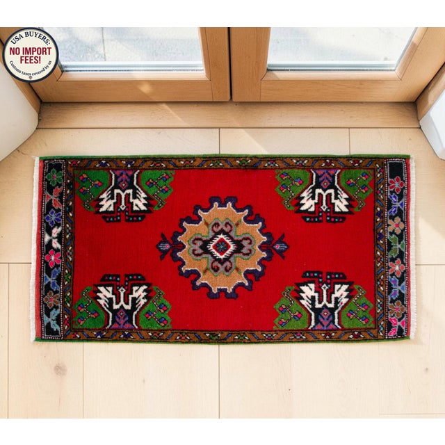 Elevate your living space with this vibrant and authentic vintage Anatolian small rug, featuring a striking red field and...