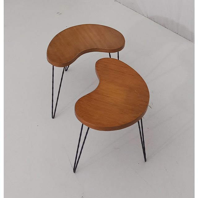 A beautifully crafted set of two small tables, designed and produced in Italy in the 1950s, showcasing the elegance and...