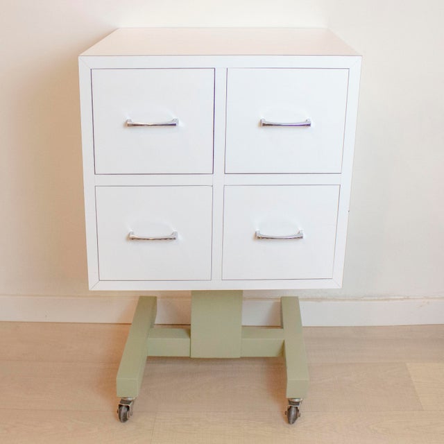 Auxiliary chest of drawers from the 1970s. Made of solid pine wood and white Formica veneer. with a green central leg and...