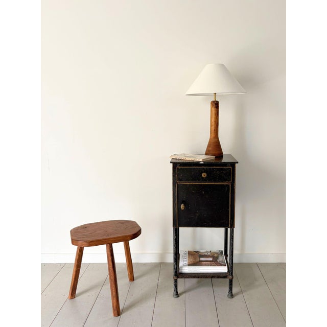 An early 20th century steel cabinet with clean modernist lines and gilt geometric highlighting. Beneath the cut stone top...