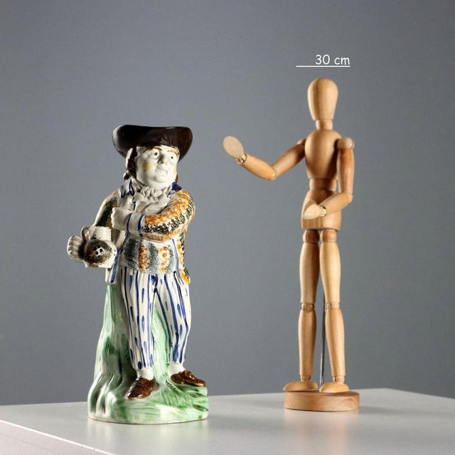 Toby polychrome ceramic jug in the shape of a man with a carafe, in 18th century common clothes. This piece is attributed...