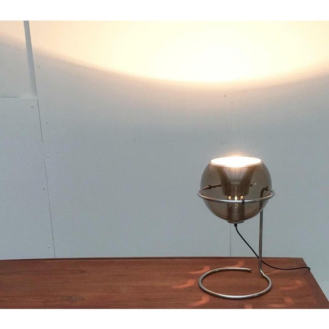 Rare Space Age table lamp with glass ball reflector. The most striking thing about this lamp is the movable reflector made...
