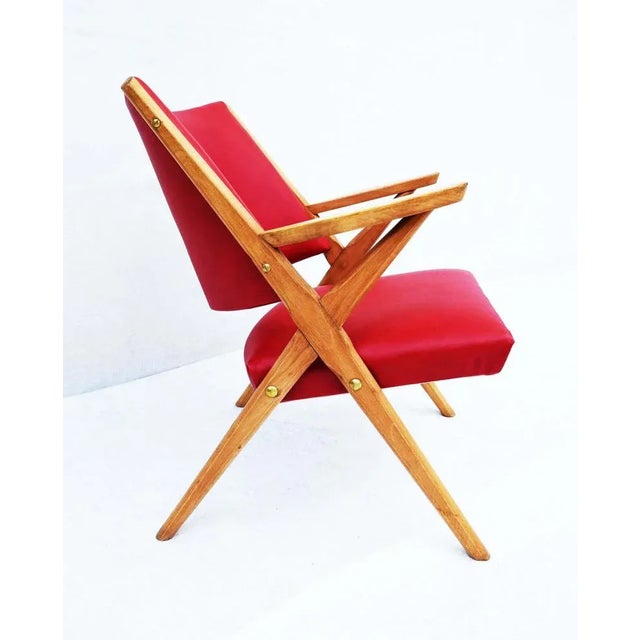 Armchair with beech structure and red skai coating. Produced in Italy in the 60s. In the real style