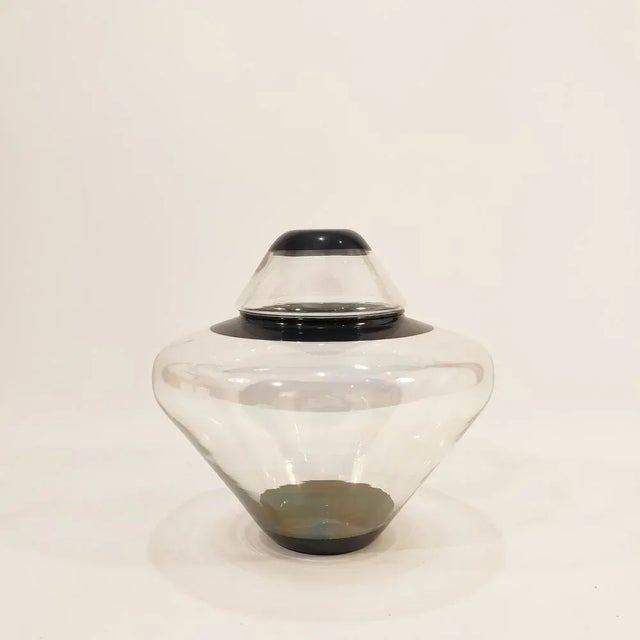 La Mediterranea 1980s glass teapot. Body divided into a vase and a lid, both in slightly iridescent transparent glass with...