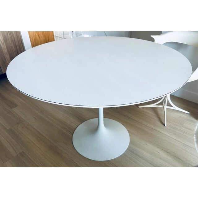 Authentic Tulip table designed by Eero Saarinen for Knoll in 1956. Round 42" wood and white laminate top on white enameled...